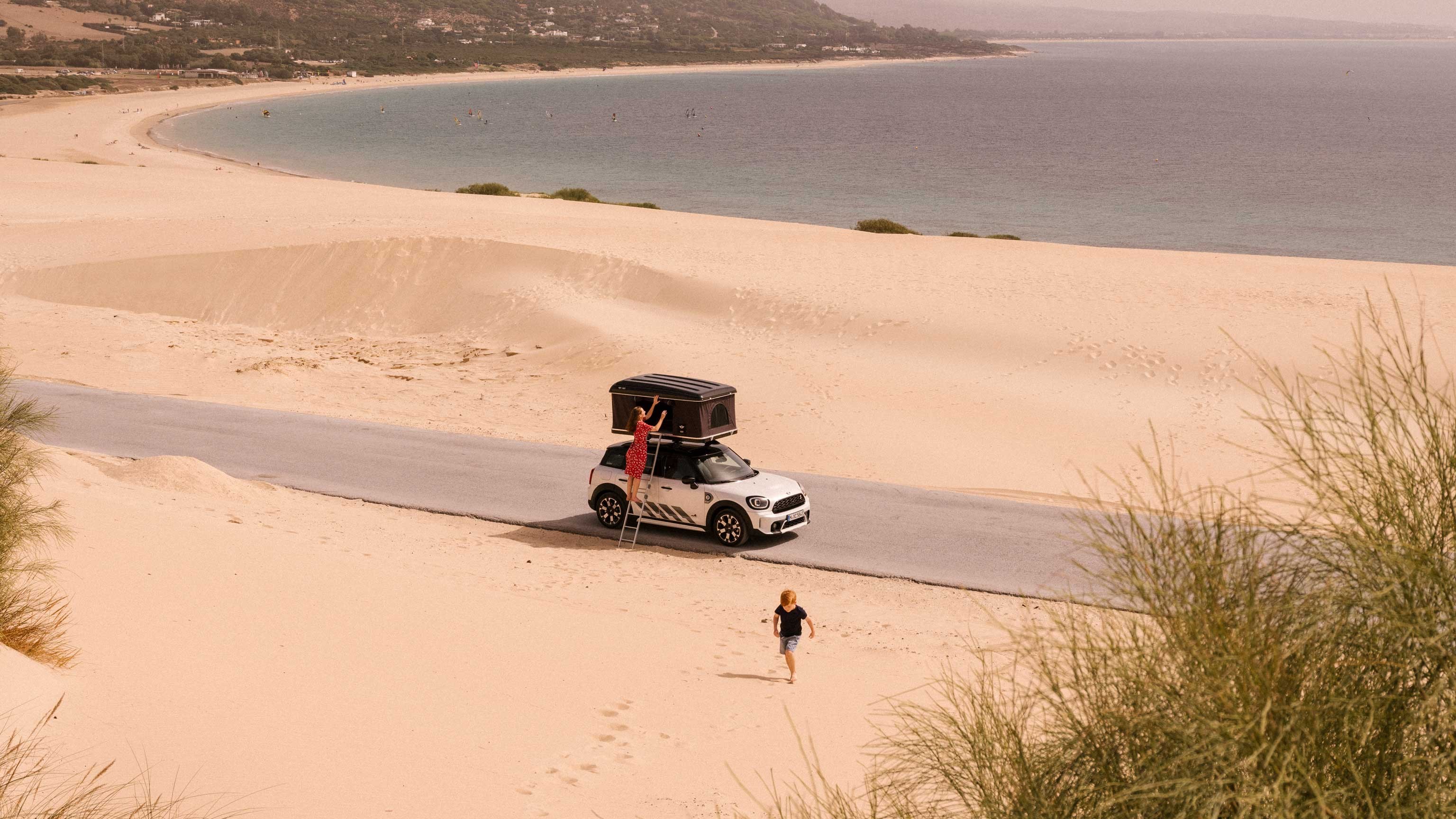 The author, her son, and the MINI Countryman in front of the shifting sand dunes of Valdevaqueros.